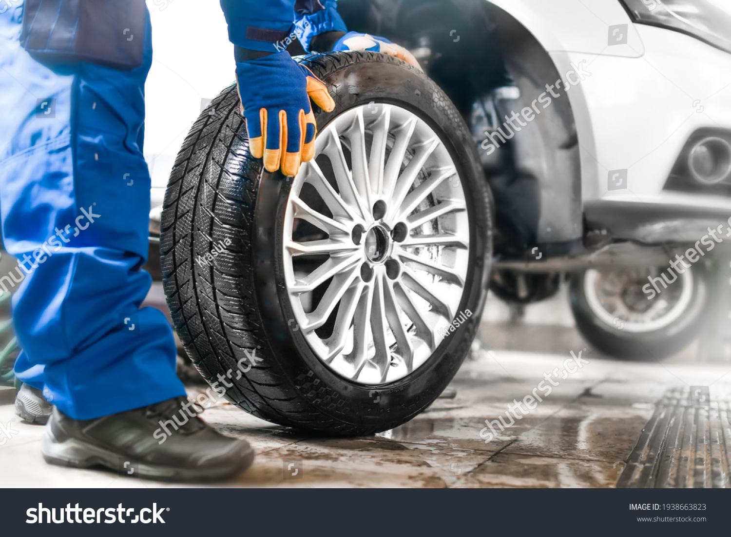 stock-photo-car-mechanic-working-in-garage-and-changing-wheel-alloy-tire-repair-or-maintenance-auto-service-1938663823.jpg