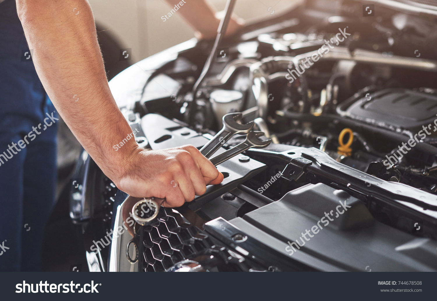 stock-photo-picture-showing-muscular-car-service-worker-repairing-vehicle-744678508.jpg